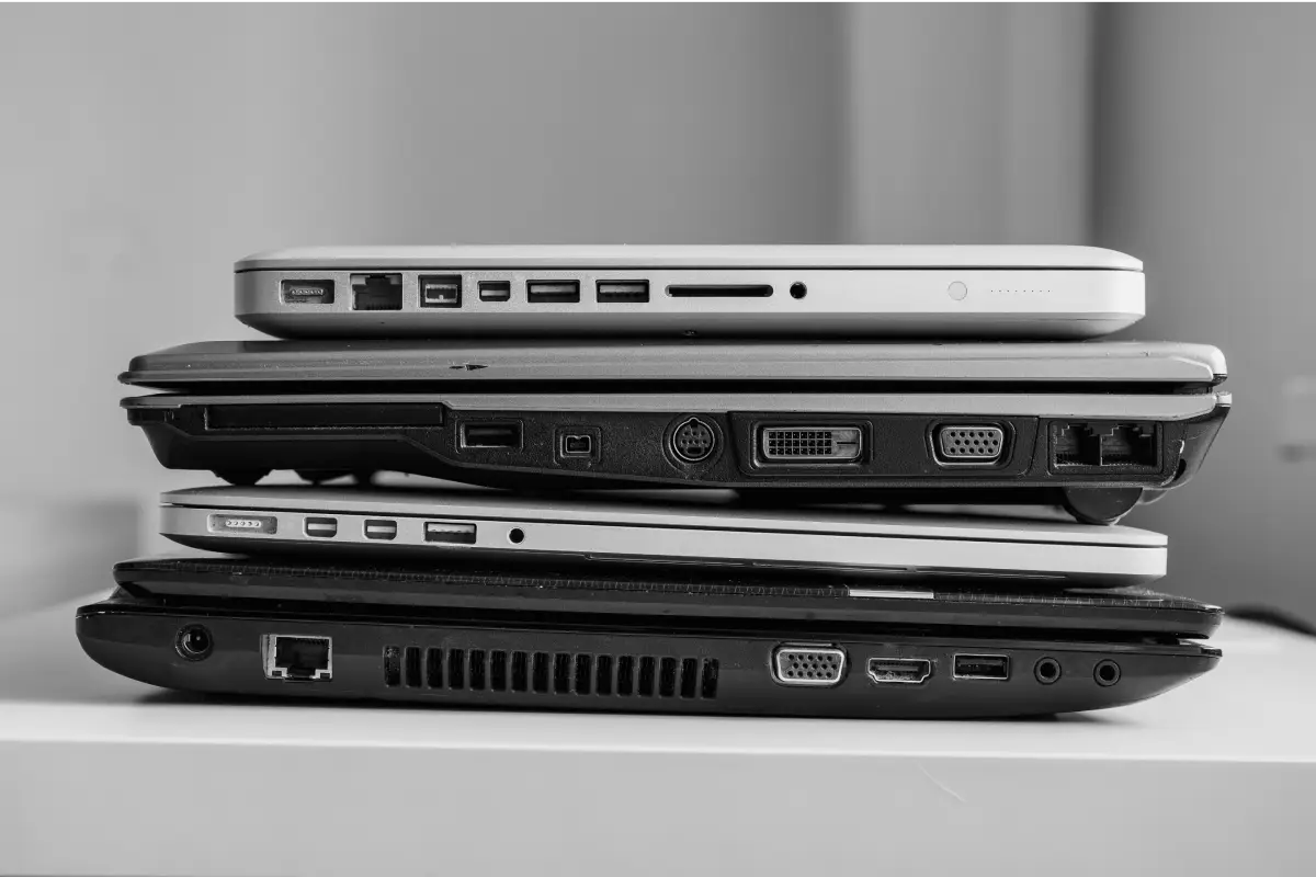stacked laptops on a table in need of itad services in Singapore