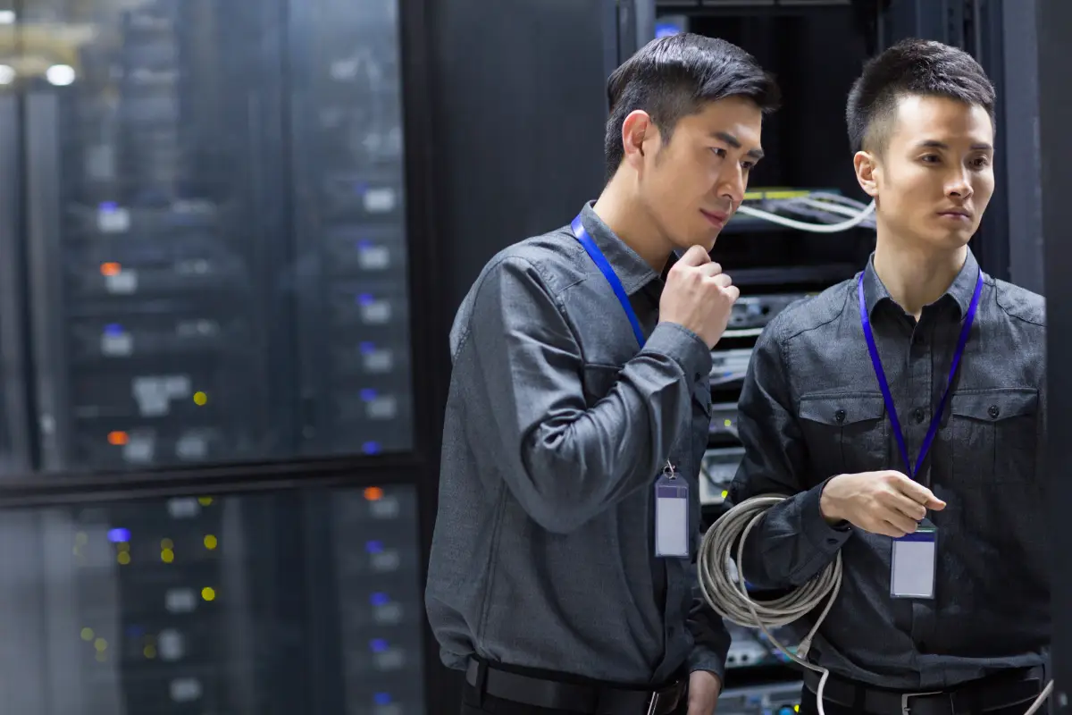 engineers in a server room preparing for ITAD services in Singapore