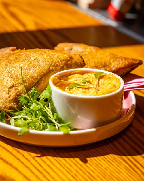Samosas with fresh dips served at the Royal Cocktail Exchange in Fitzrovia, London
