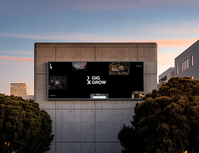 Outdoor digital billboard on concrete building at sunset displaying 'GIG GROW' with small images.