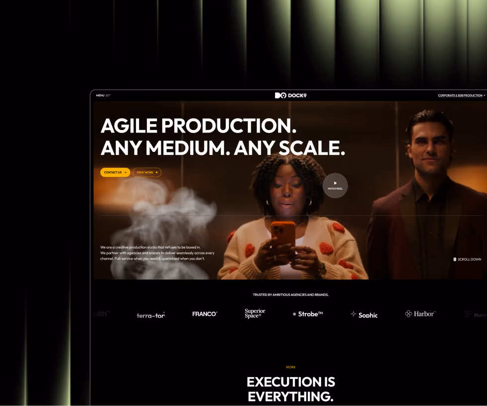 Website homepage with header text 'Agile Production. Any medium. Any scale.' featuring a woman looking at her phone and a man beside her, plus buttons for Contact Us and View Work, and logos of trusted agencies below.