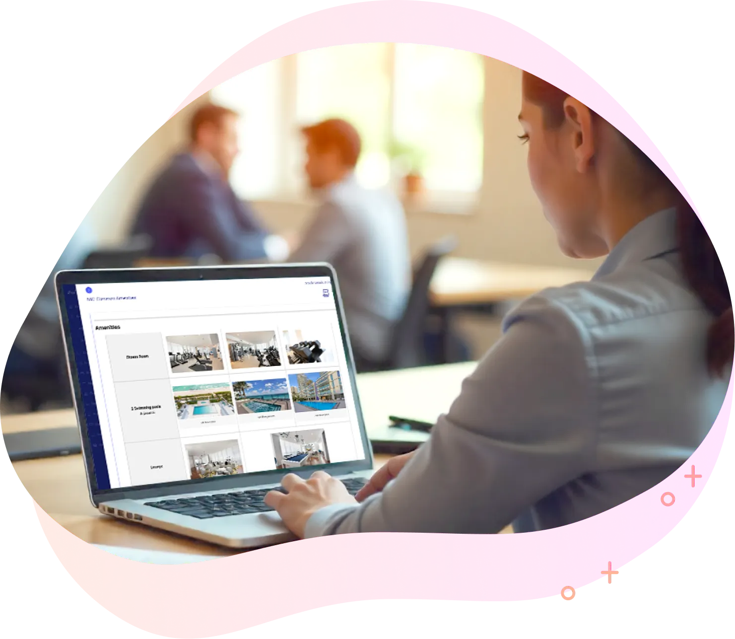 Person using laptop showing images of amenities like fitness room and swimming pools on screen.