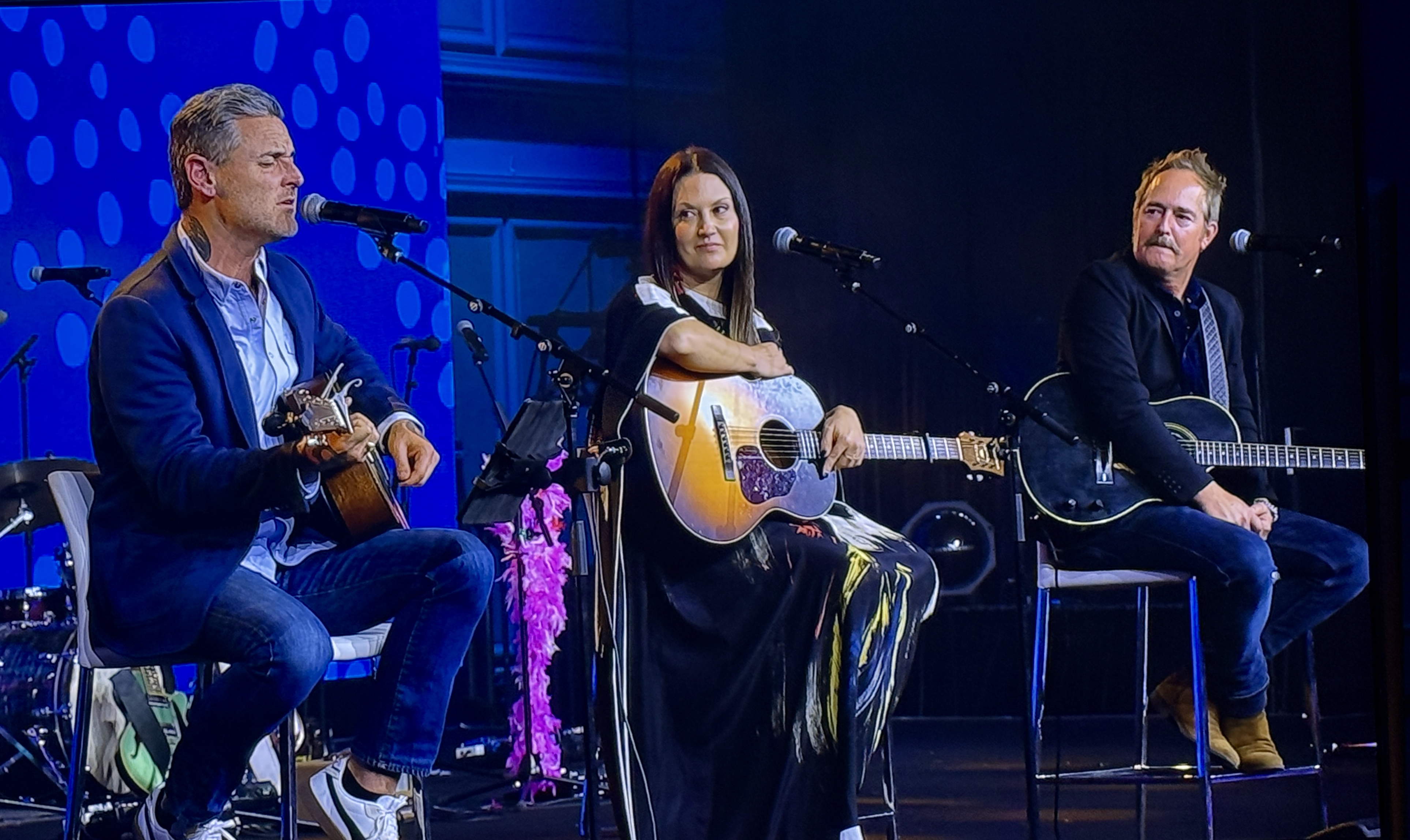 David Hodges, Emerson Hart, and Natalie Hemby performing songs and sharing stories during a corporate event songwriter round experience.