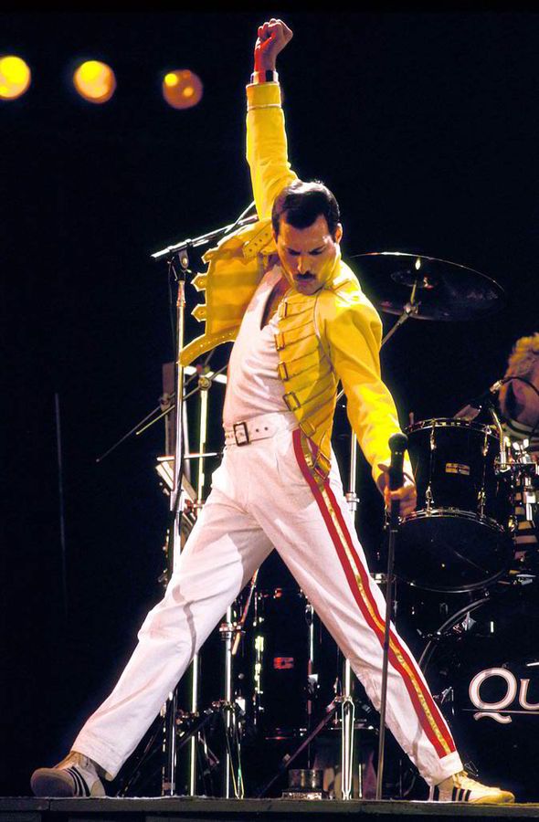 This may contain: elvis presley performing on stage with his arms in the air