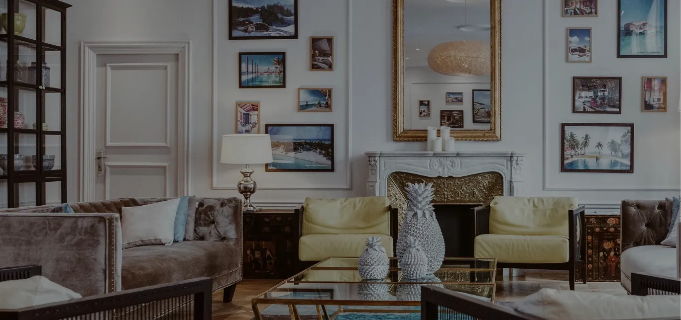 Elegantly furnished living room with a gallery wall and mirrored fireplace