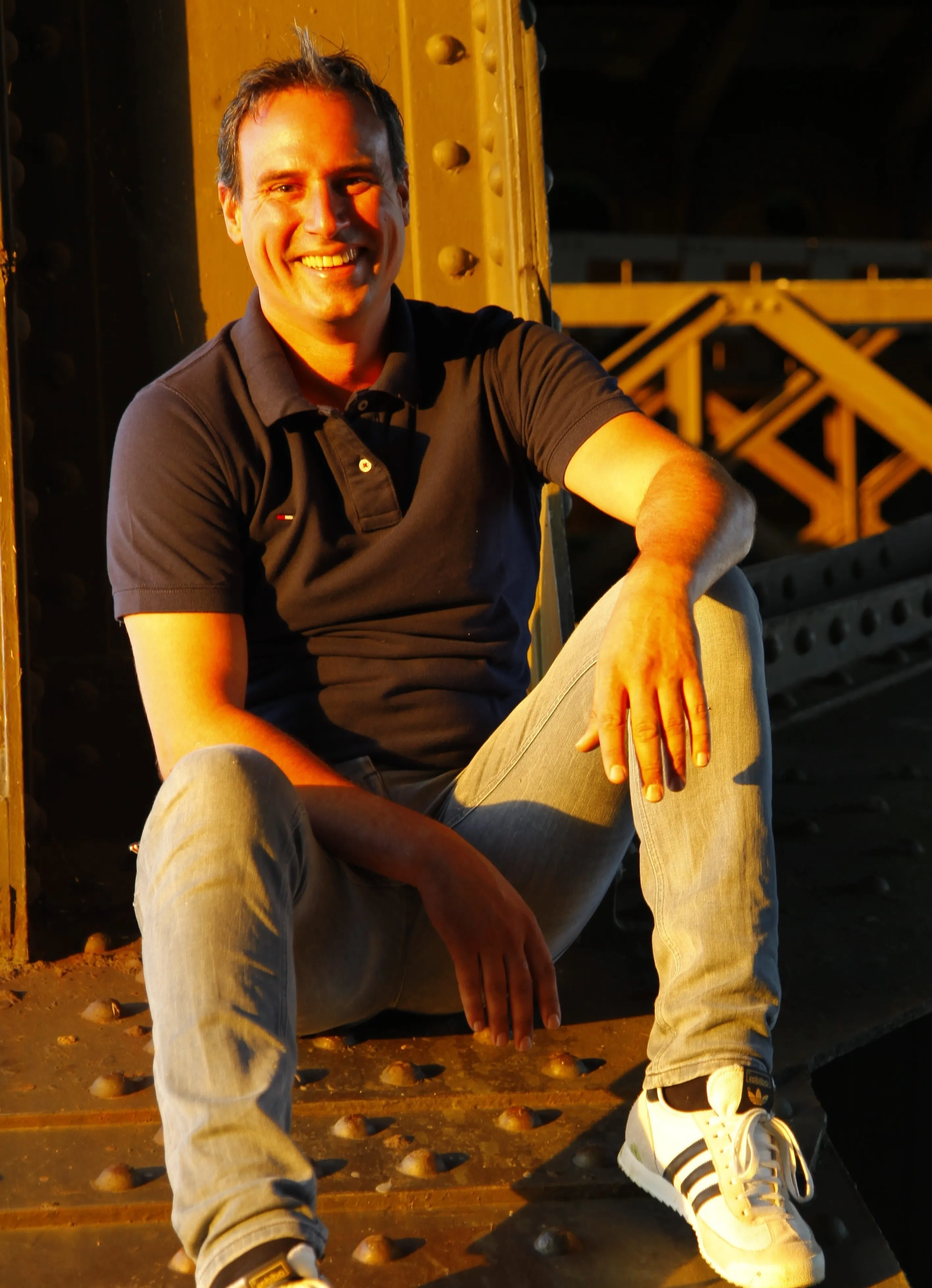 A man sitting on a bridge