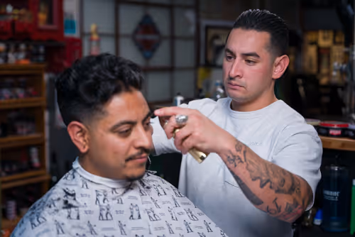 A cinematic image of a barber cutting hair from their website we developed
