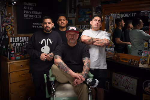 A cinematic image of our clients team in their barbershop from their website we designed and developed