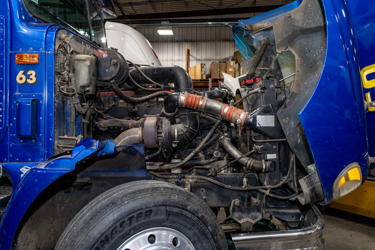 blue semi truck with the hood up or a repair 