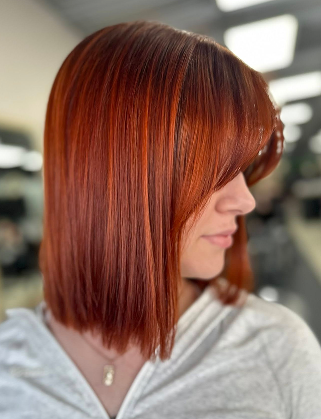 Close-up of long, wavy hair with a blend of light brown and blonde highlights.