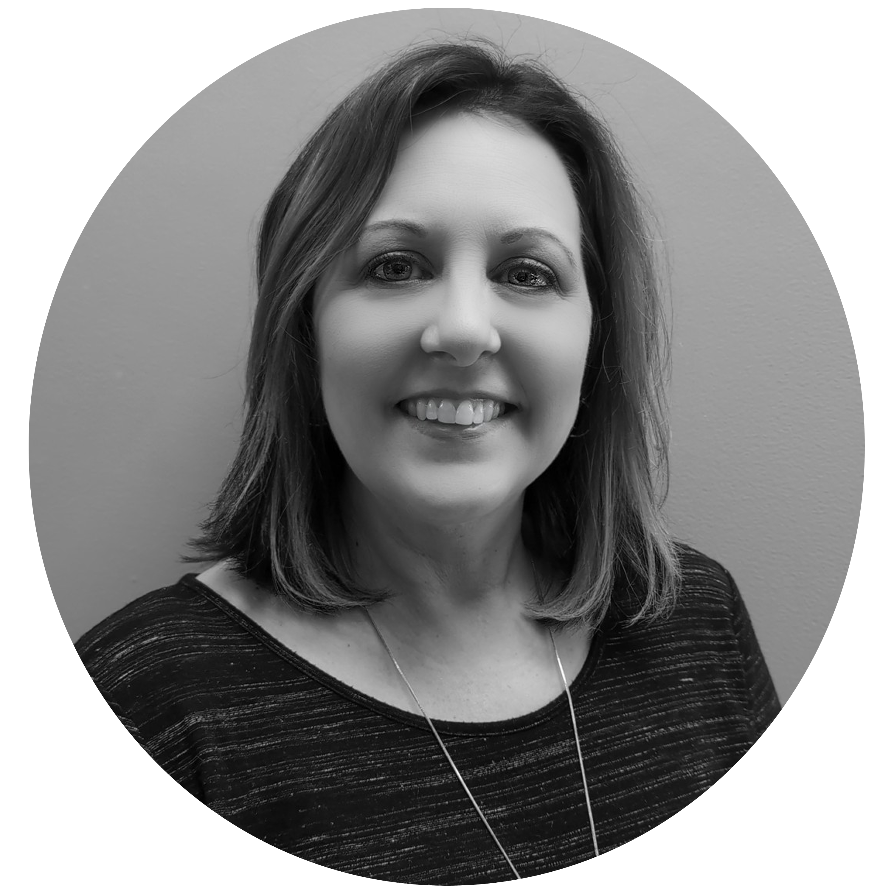 Smiling woman with shoulder-length hair wearing a striped top and necklace, against a plain background.