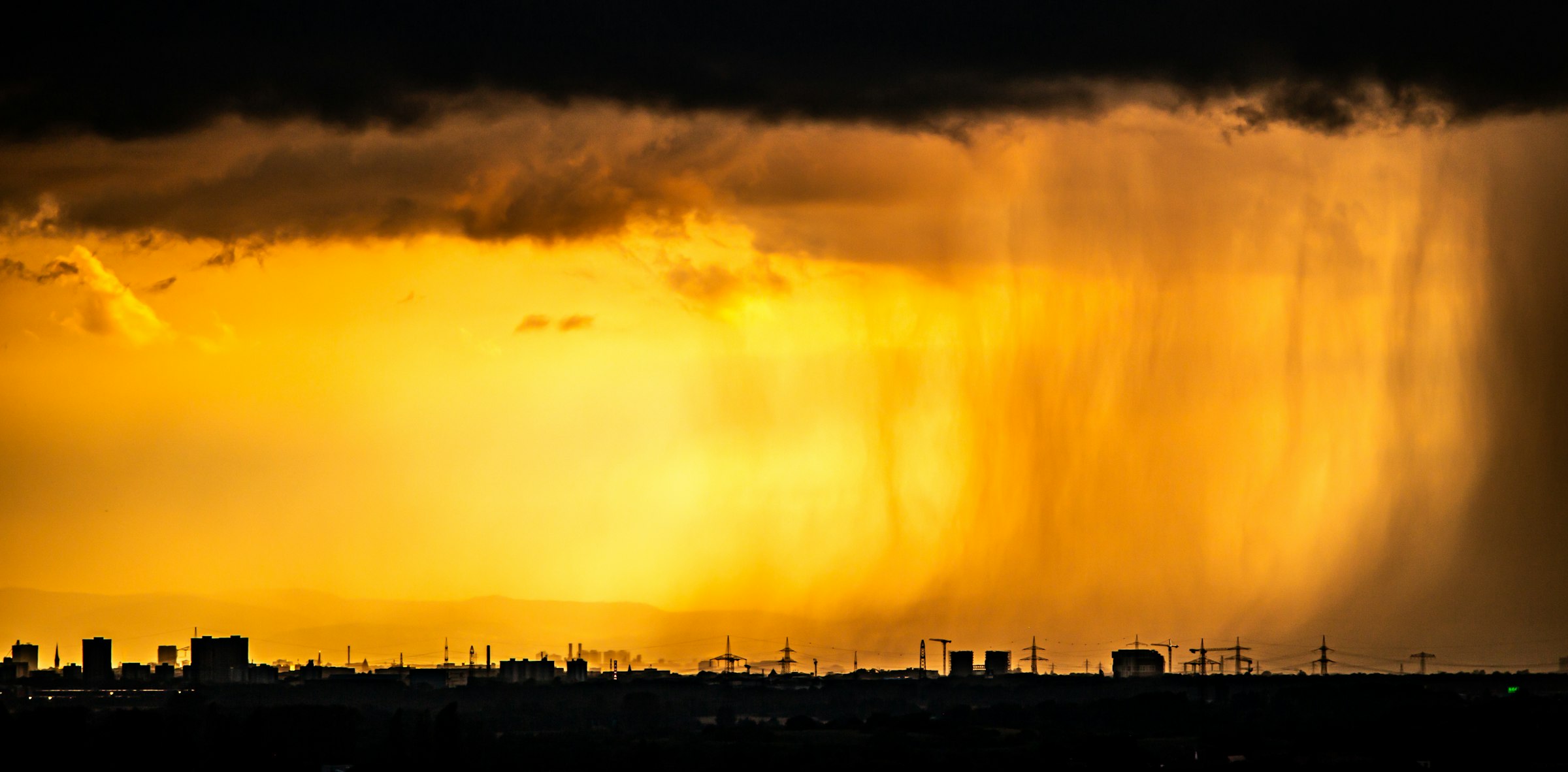 Dark storm clouds gathering over a city skyline