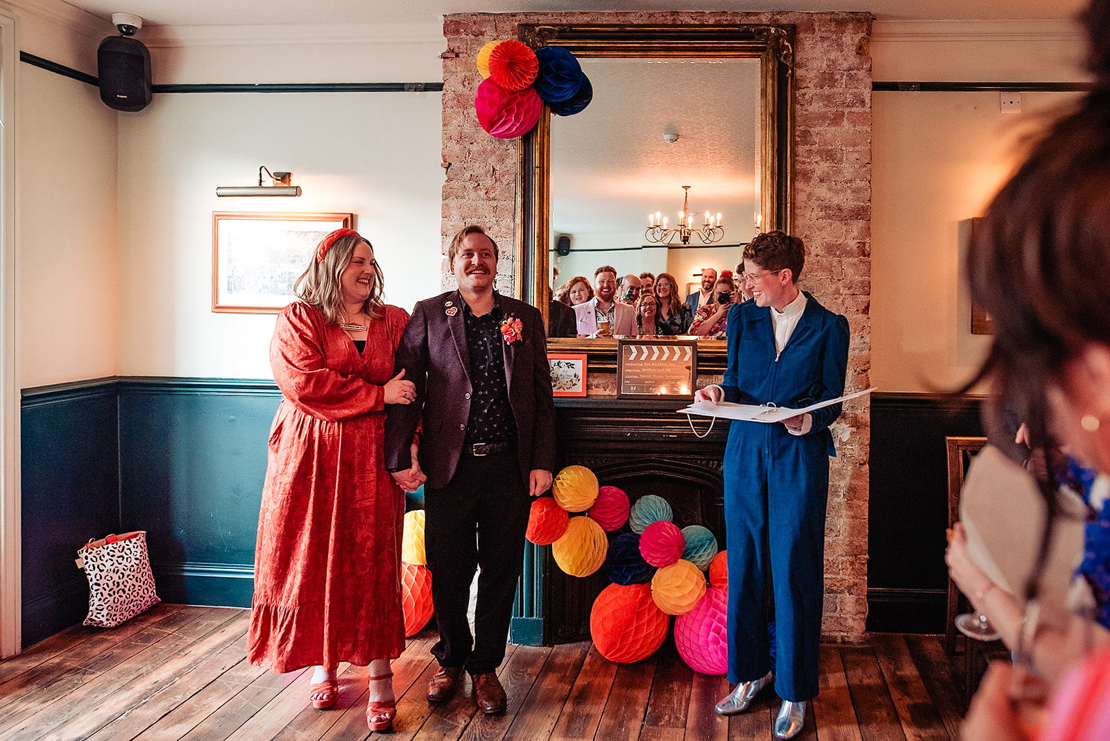 Abi and Matt smile and laugh as Chloe delivers their wedding ceremony