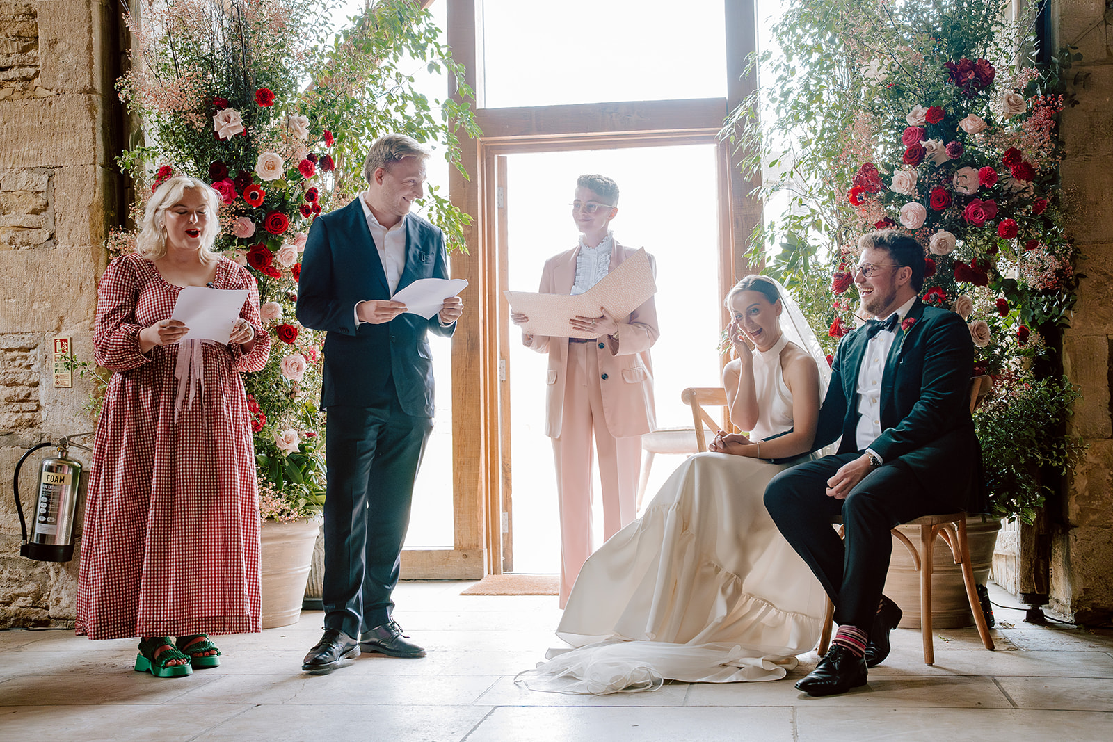 A woman and man read out something funny at Jess and Chris' wedding ceremony