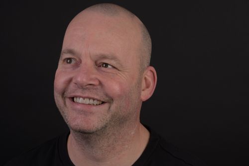 Happy man with a broad smile and restored teeth.