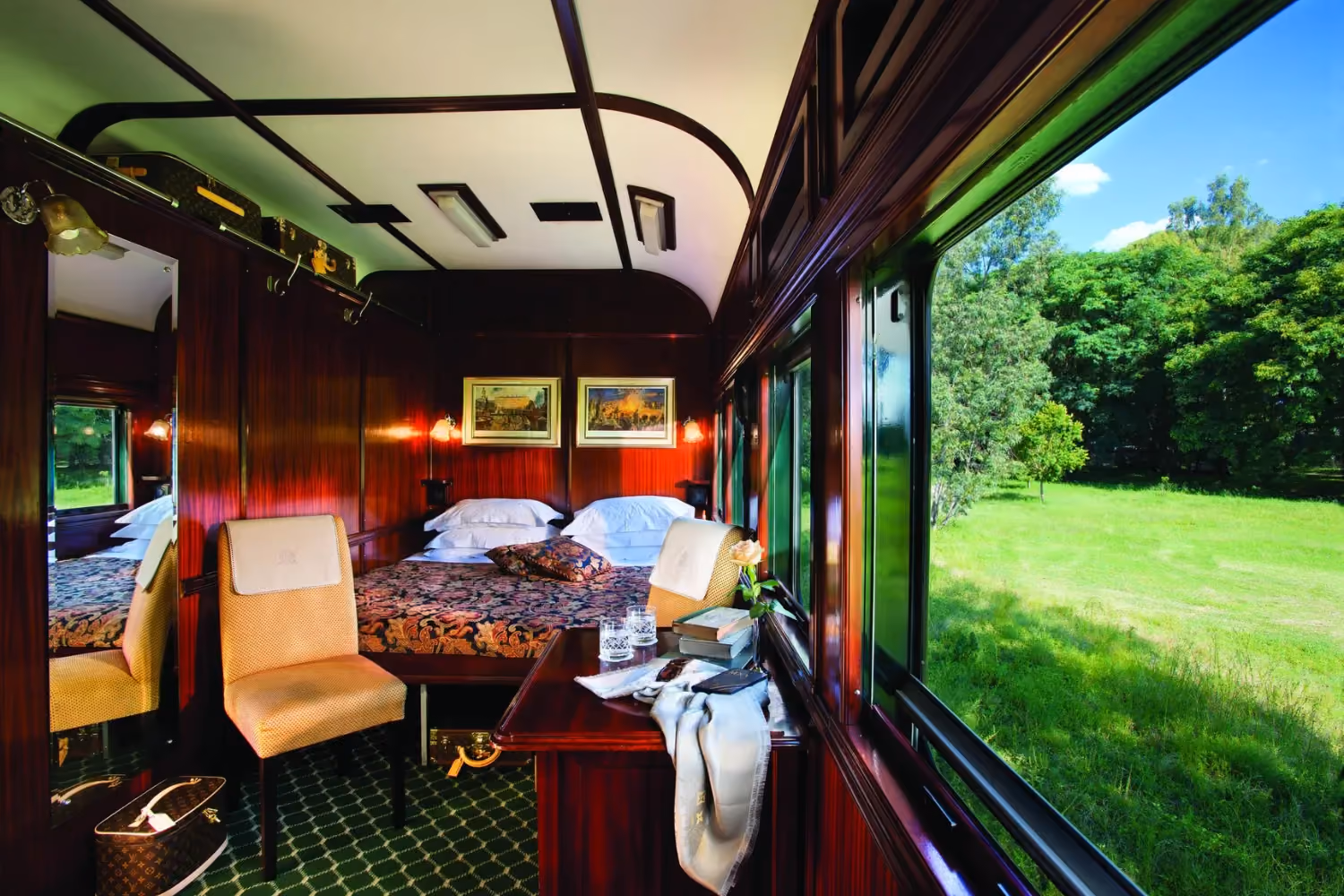 Luxury interior of a train with bed and landscape passing by