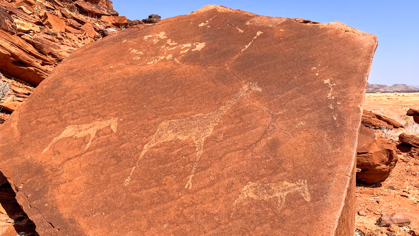 Petroglyphs carved into ancient rock in remote Namibia.