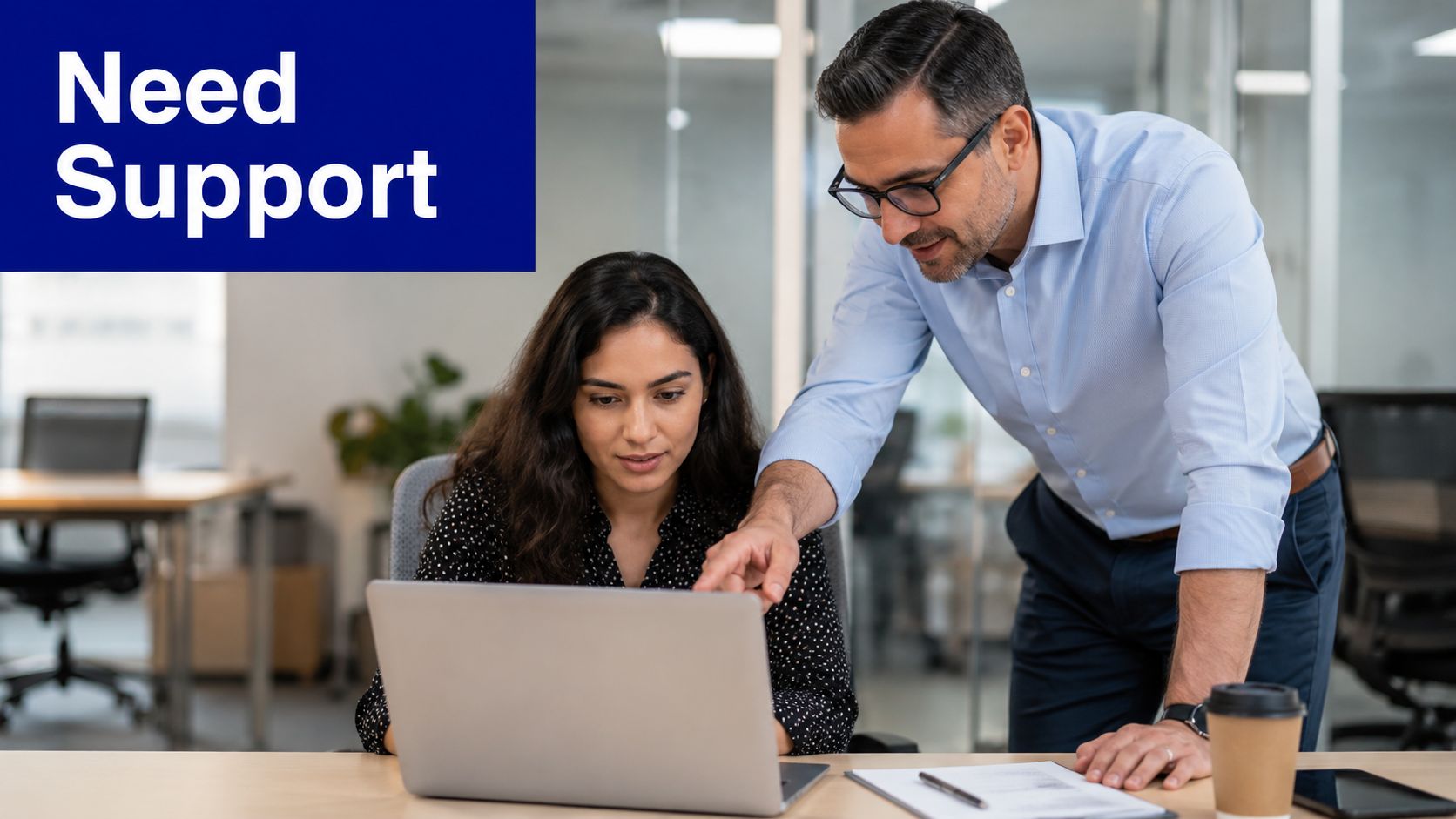 A professional manager provides guidance and support to an employee during an office performance review session.