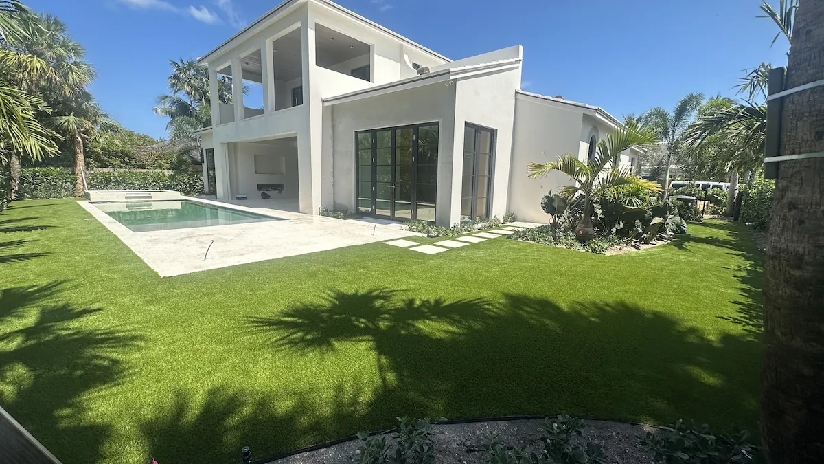 a large white house with a pool in front of it