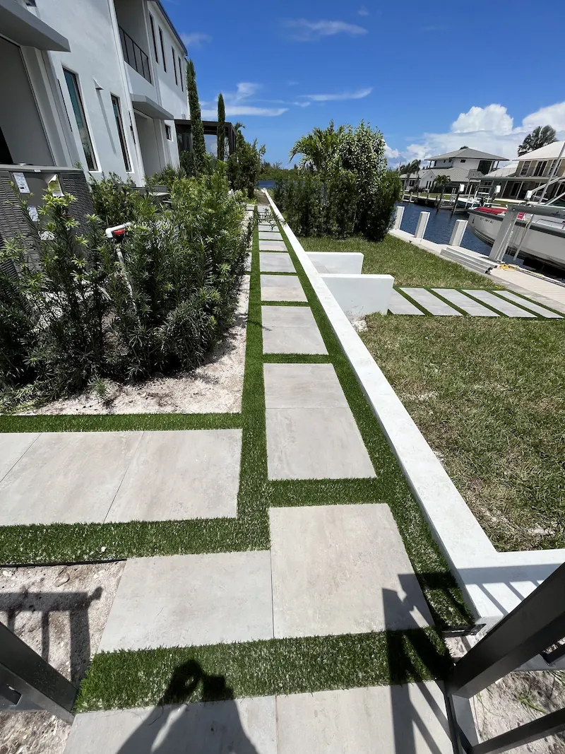 a walkway with grass on the side of it
