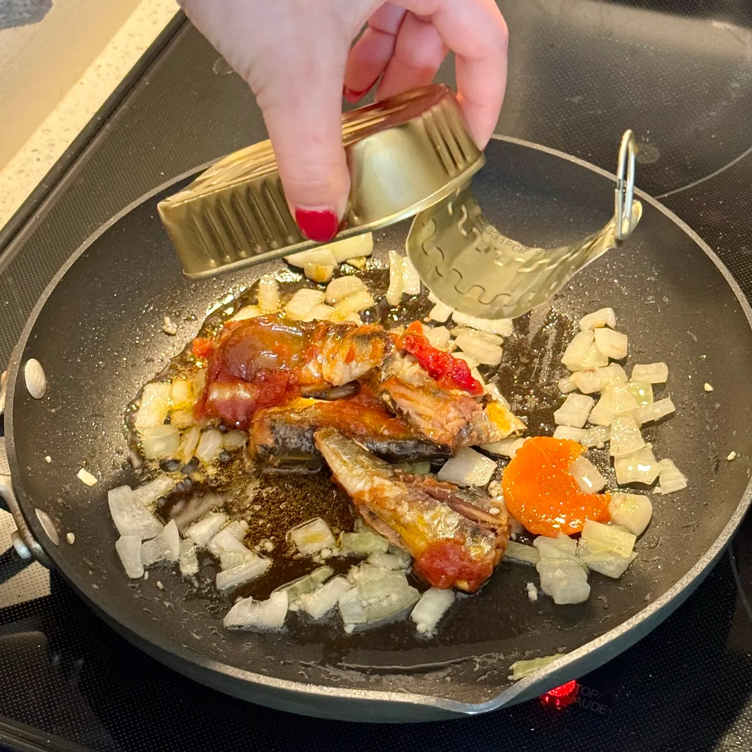 Sardines heating in a pan
