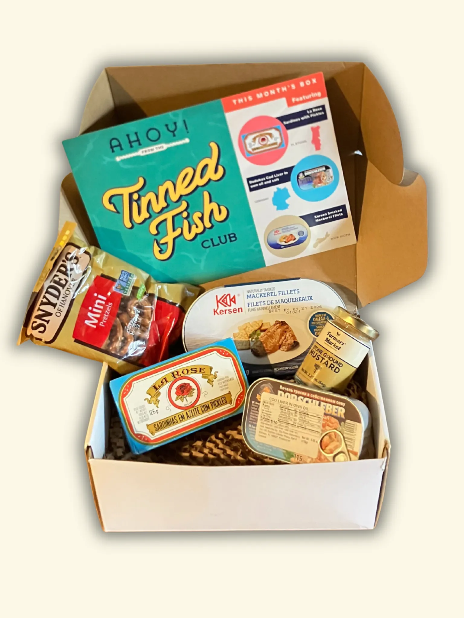 Tinned Fish Club August box with three tins of artisanal canned seafood