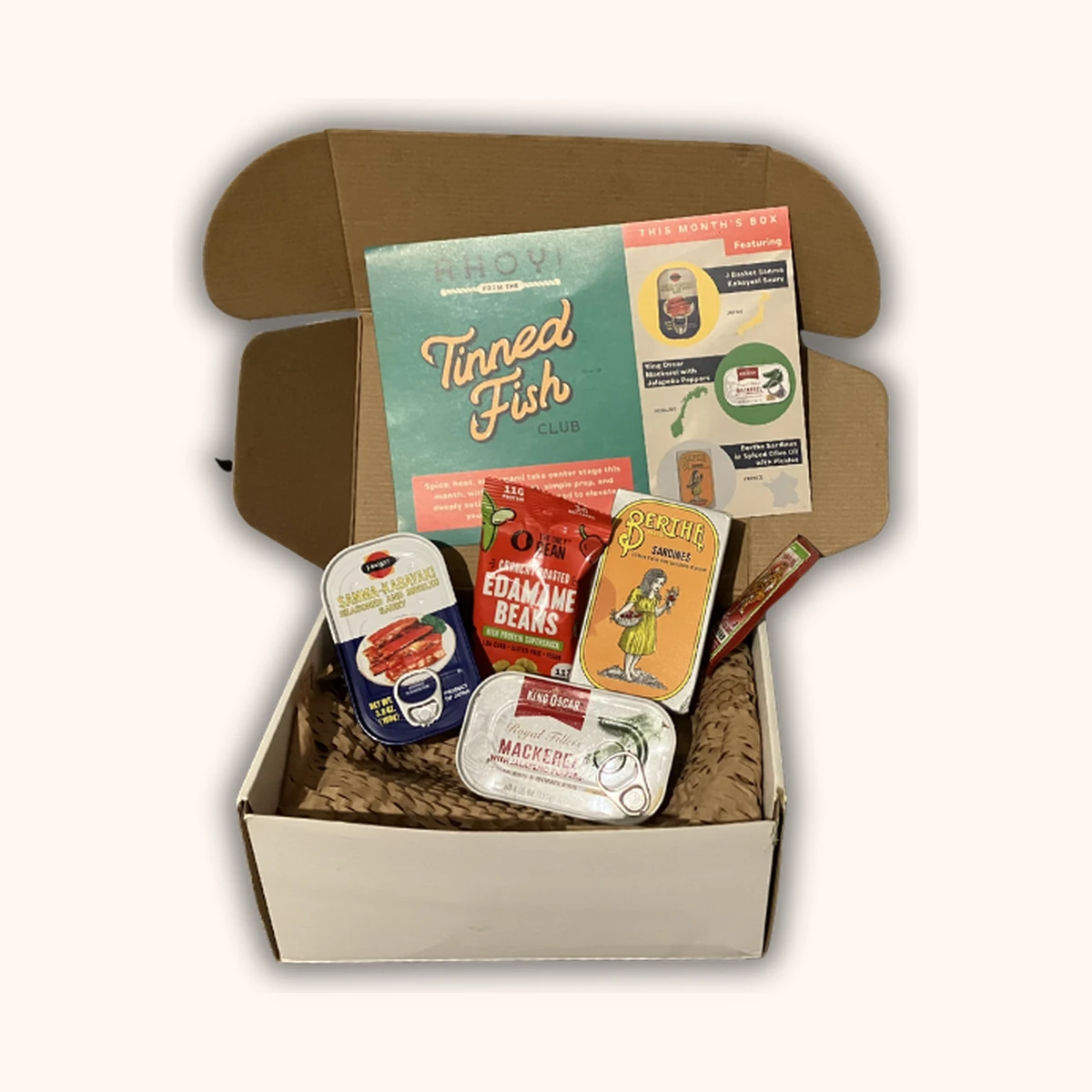 Tinned Fish Club March box with three premium tins and paired condiments