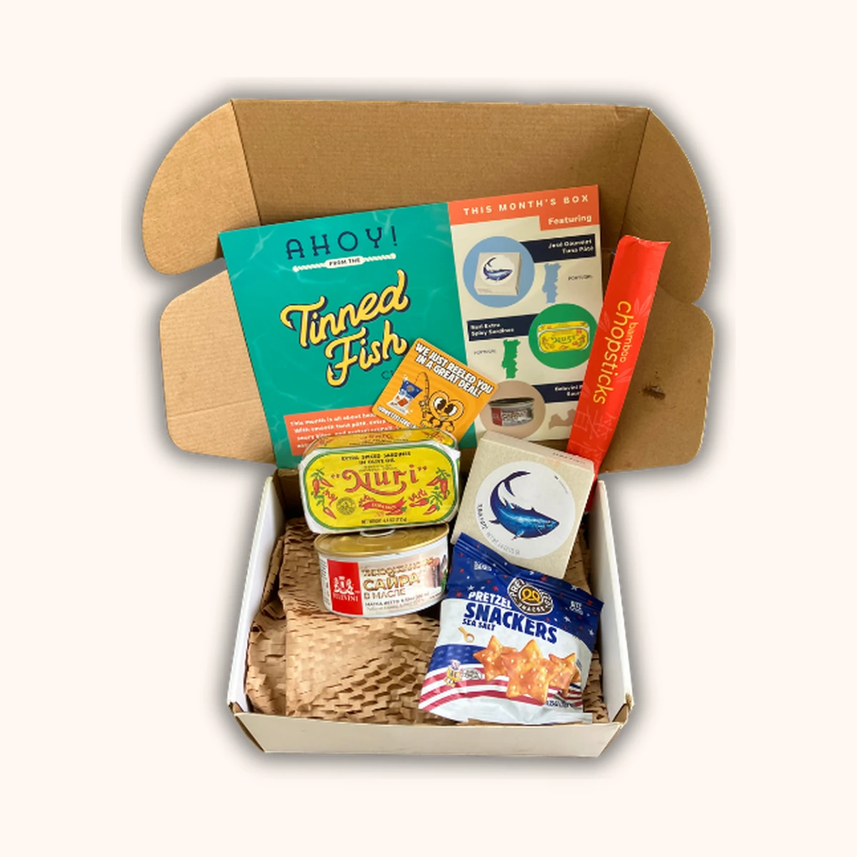 Tinned Fish Club August box with three tins of artisanal canned seafood