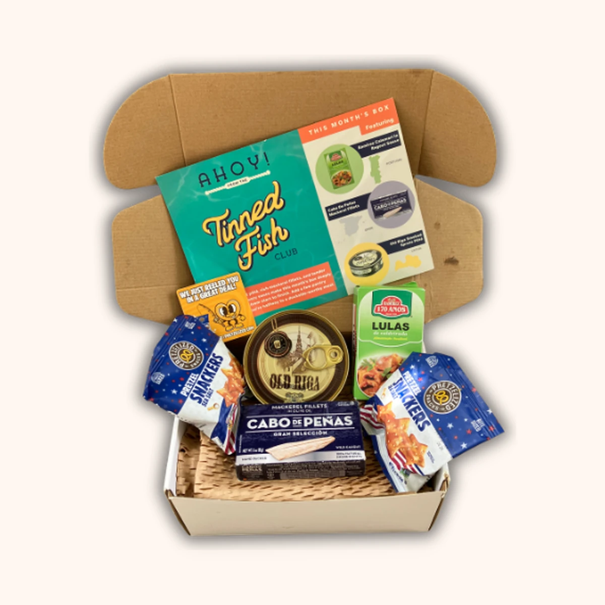Tinned Fish Club June box with three curated tins, paired snacks and recipe cards