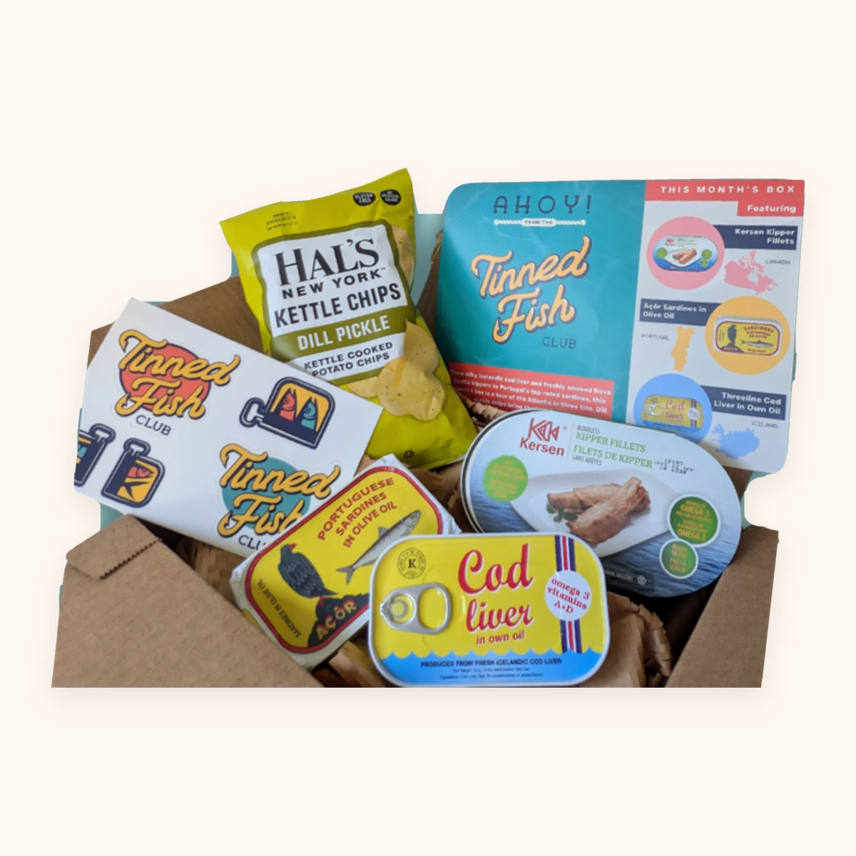 Tinned Fish Club July box with Kersen kipper fillets, Açôr sardines, Threeline cod liver and dill pickle chips