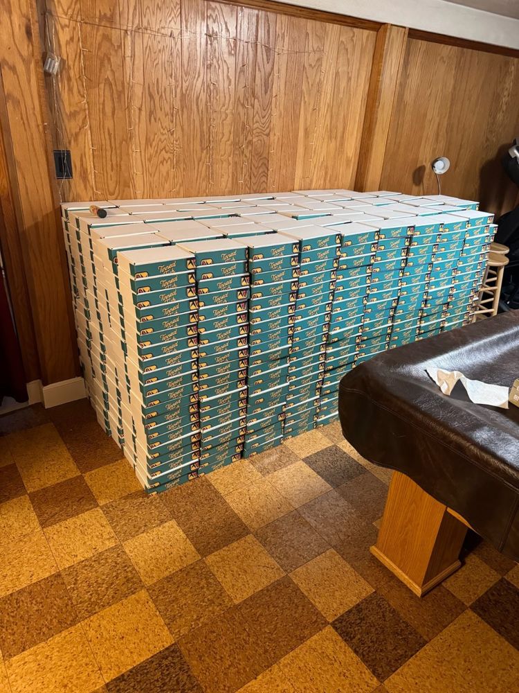 Hundreds of teal boxes stacked in a wood-panelled basement