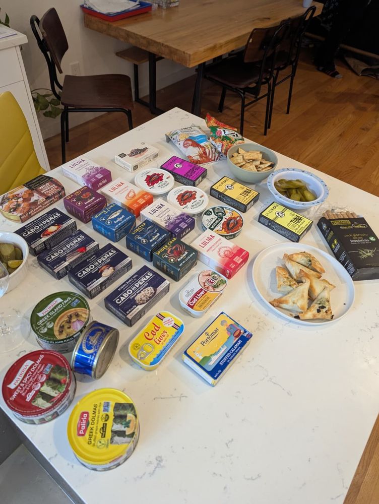 Dozens of tins laid out on a kitchen counter for a taste test