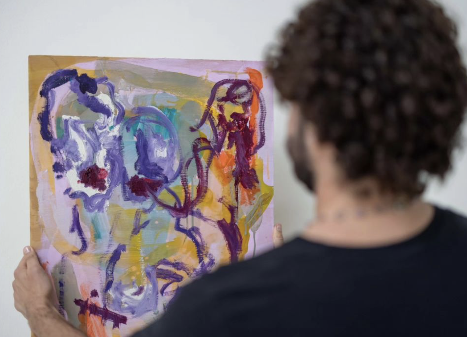 ari holding a painting