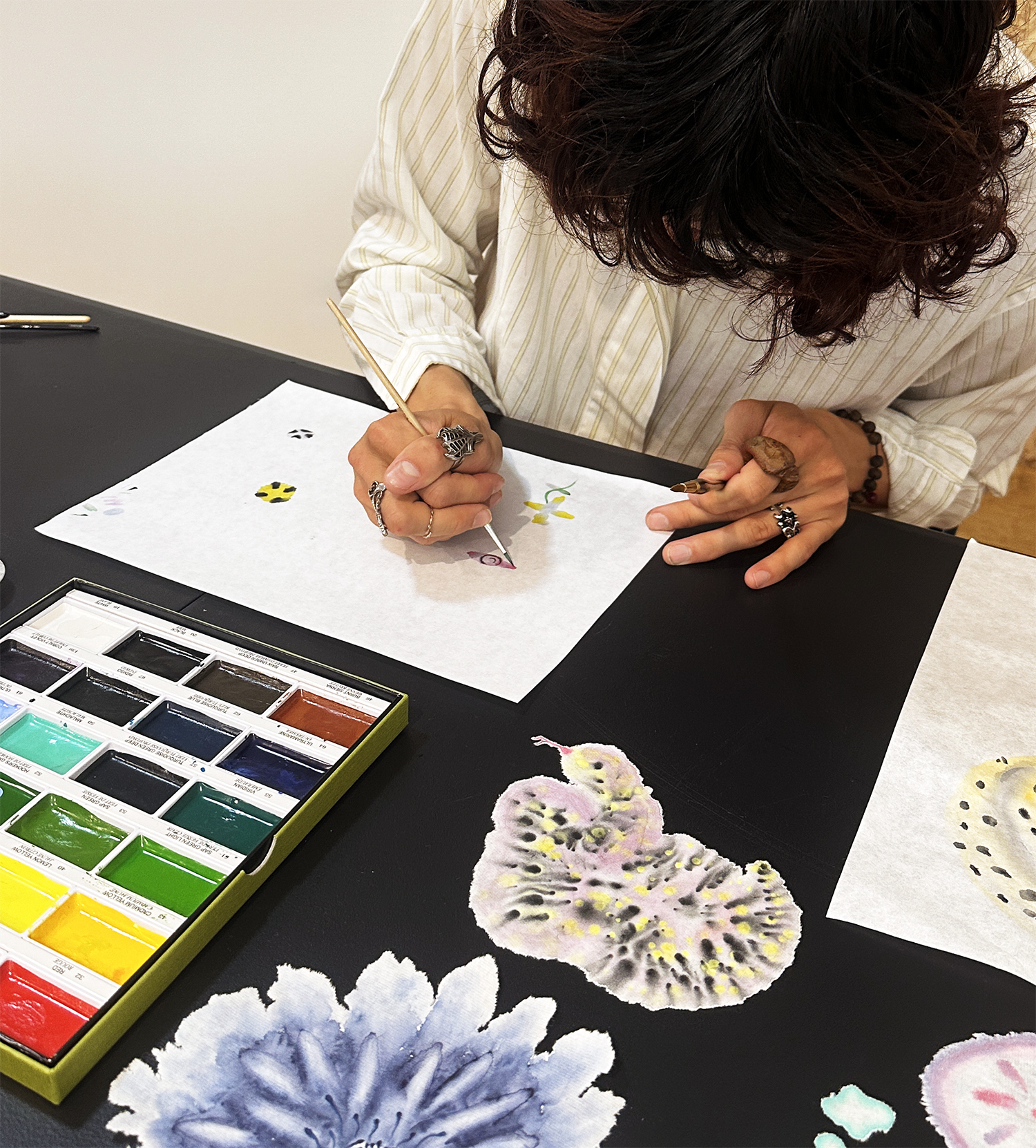 ari holding a painting