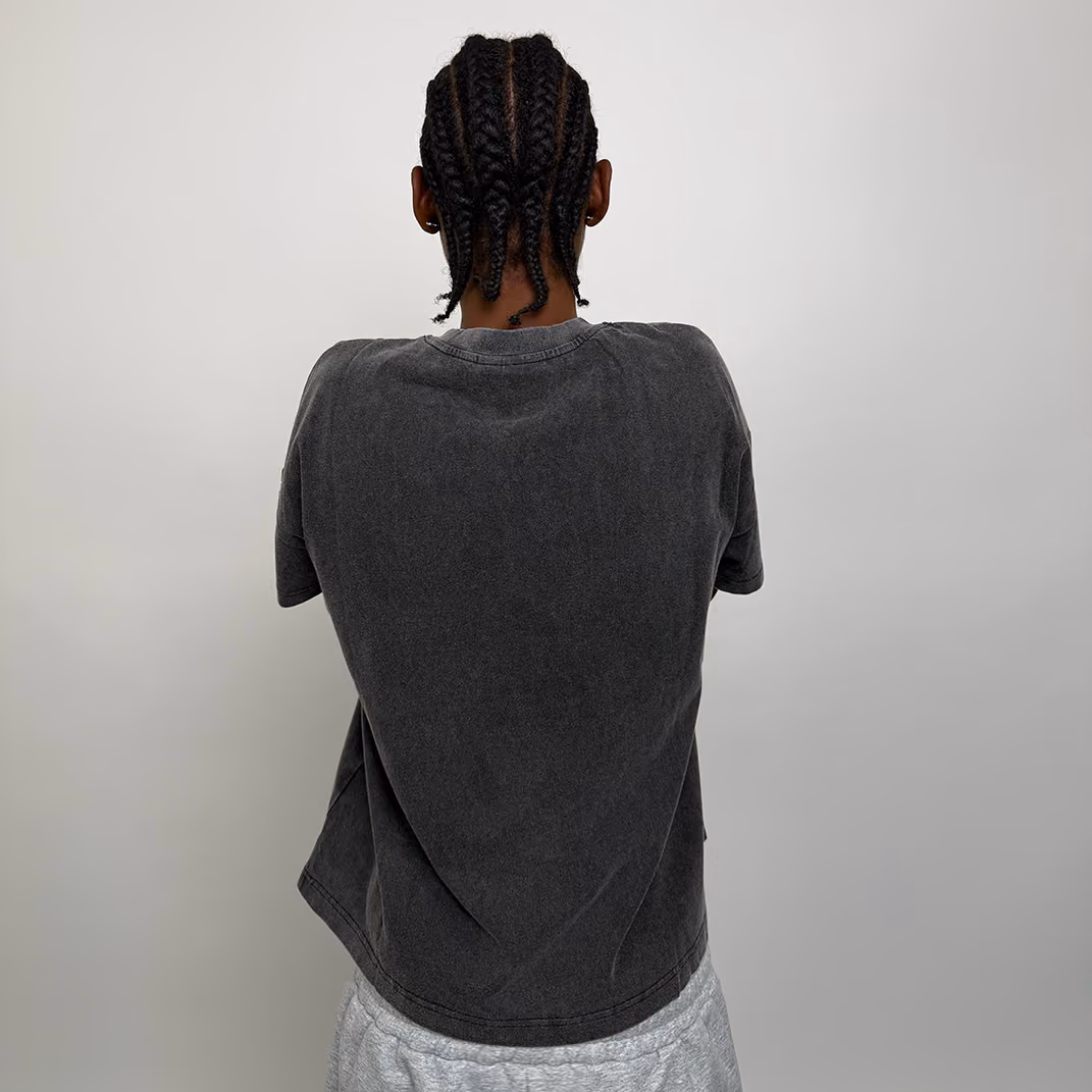 Introducing our Midriff Tee, the epitome of casual chic crafted from 100% organic cotton for unparalleled comfort and sustainability. It's boxy fit offers a relaxed yet stylish silhouette, perfect for everyday wear. Featuring an embossed logo on the sleeve, this tee exudes subtle sophistication. With shortened sleeves and unisex sizing, it's a versatile wardrobe essential for all. Available in a range of colors including charcoal, black, ivory, and white, you can effortlessly elevate your ensemble with any shade. Explore eco-conscious fashion with our Midriff Tee collection.