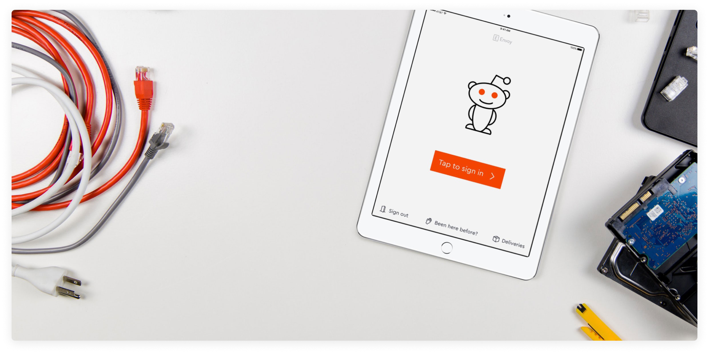 Ipad on reddit on table , with cables