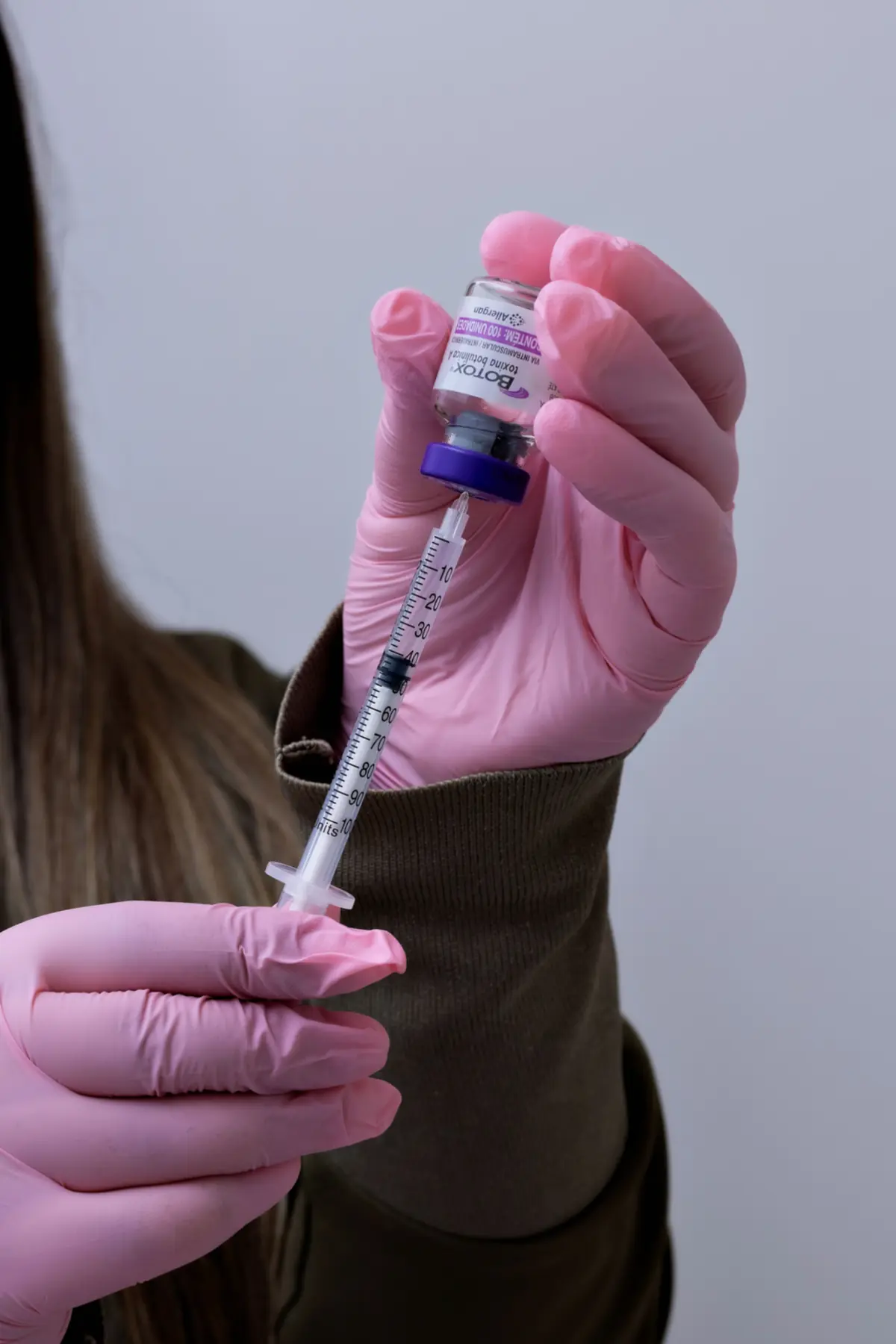 Medical professional preparing an injectable medication