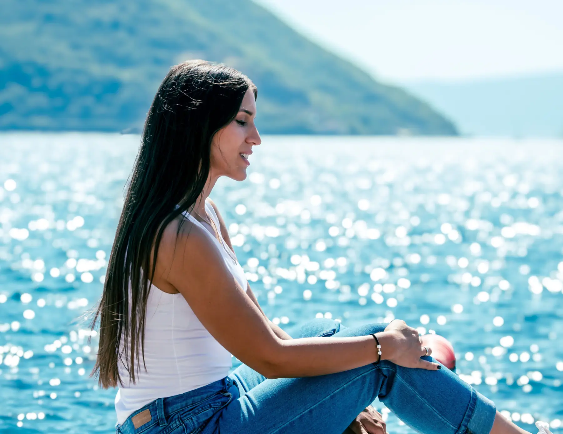 Woman relaxing near the waterfront, representing individualized thyroid evaluation and treatment at Hagen Health in Mukilteo, WA.