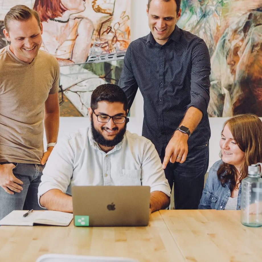 People Describing a project in front of a Laptop