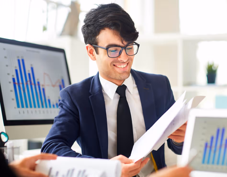 A professional man in a suit attentively examines a paper, possibly discussing a 'Hire NetSuite Contractor' opportunity.
