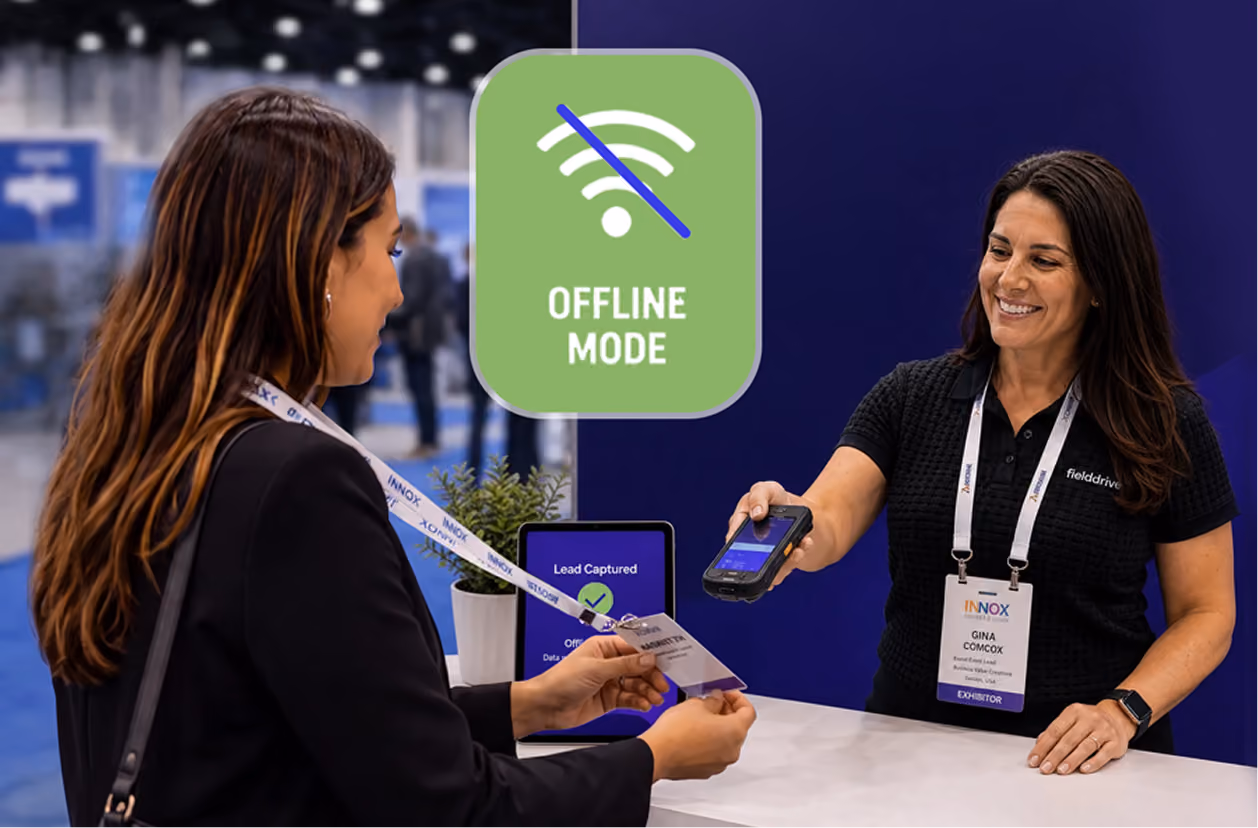 Two women at a booth exchanging a badge, with offline mode icon and tablet showing lead captured.