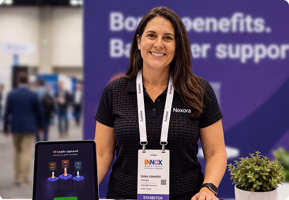 Smiling woman with Nexora shirt at exhibition booth holding a tablet displaying lead capture results.