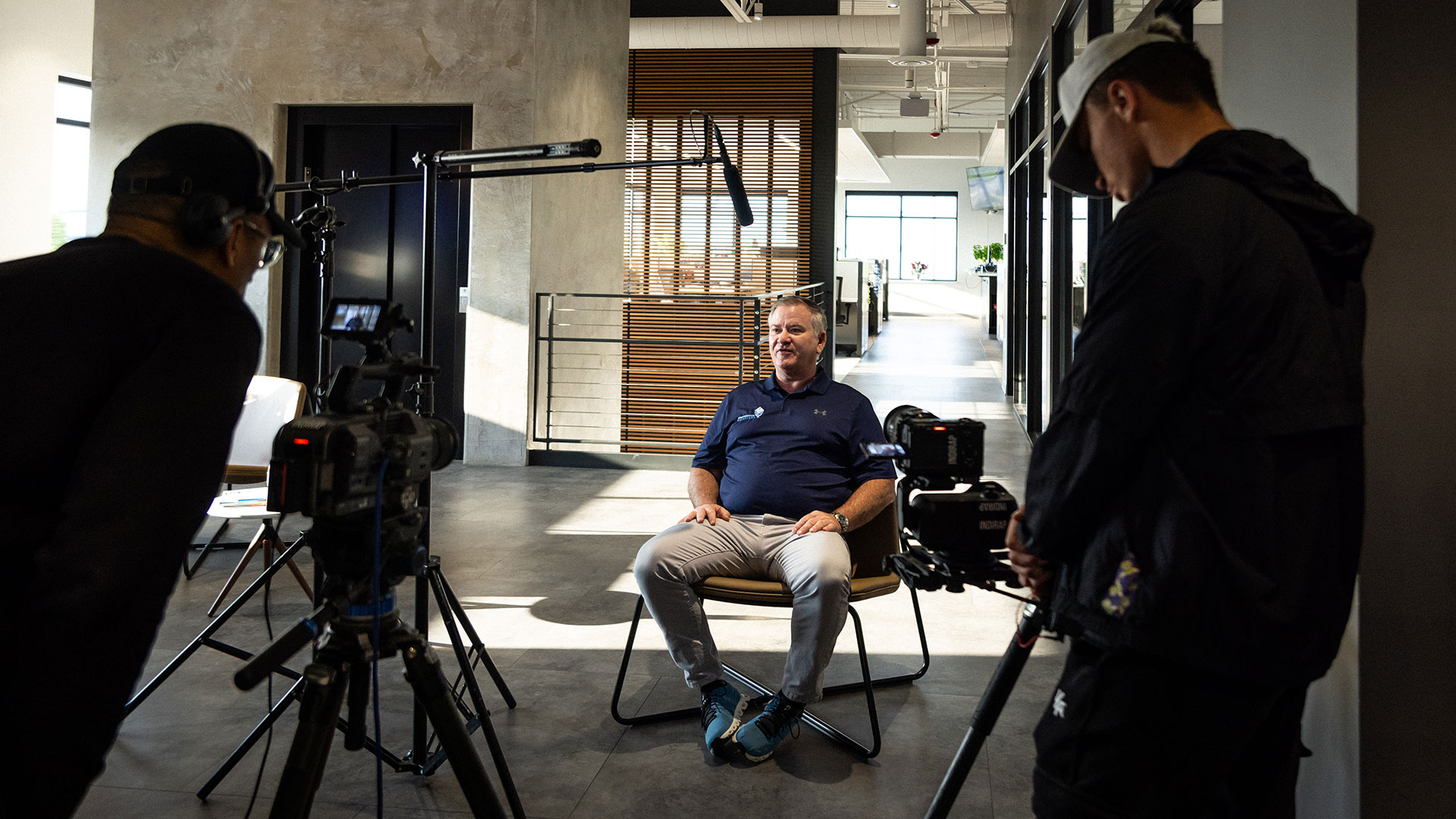 Man sitting before cameras