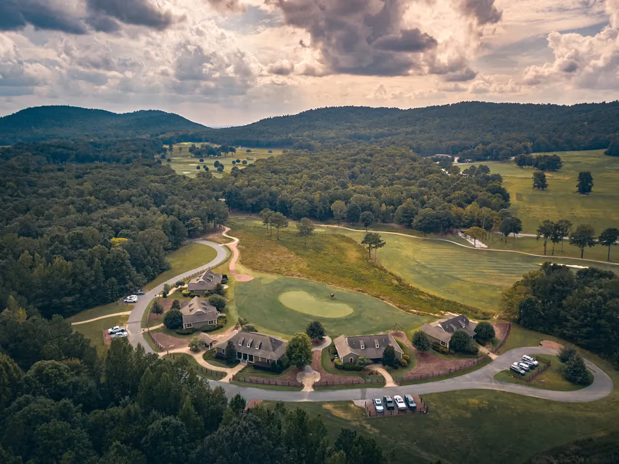 Putting Green surrounded by land and trees