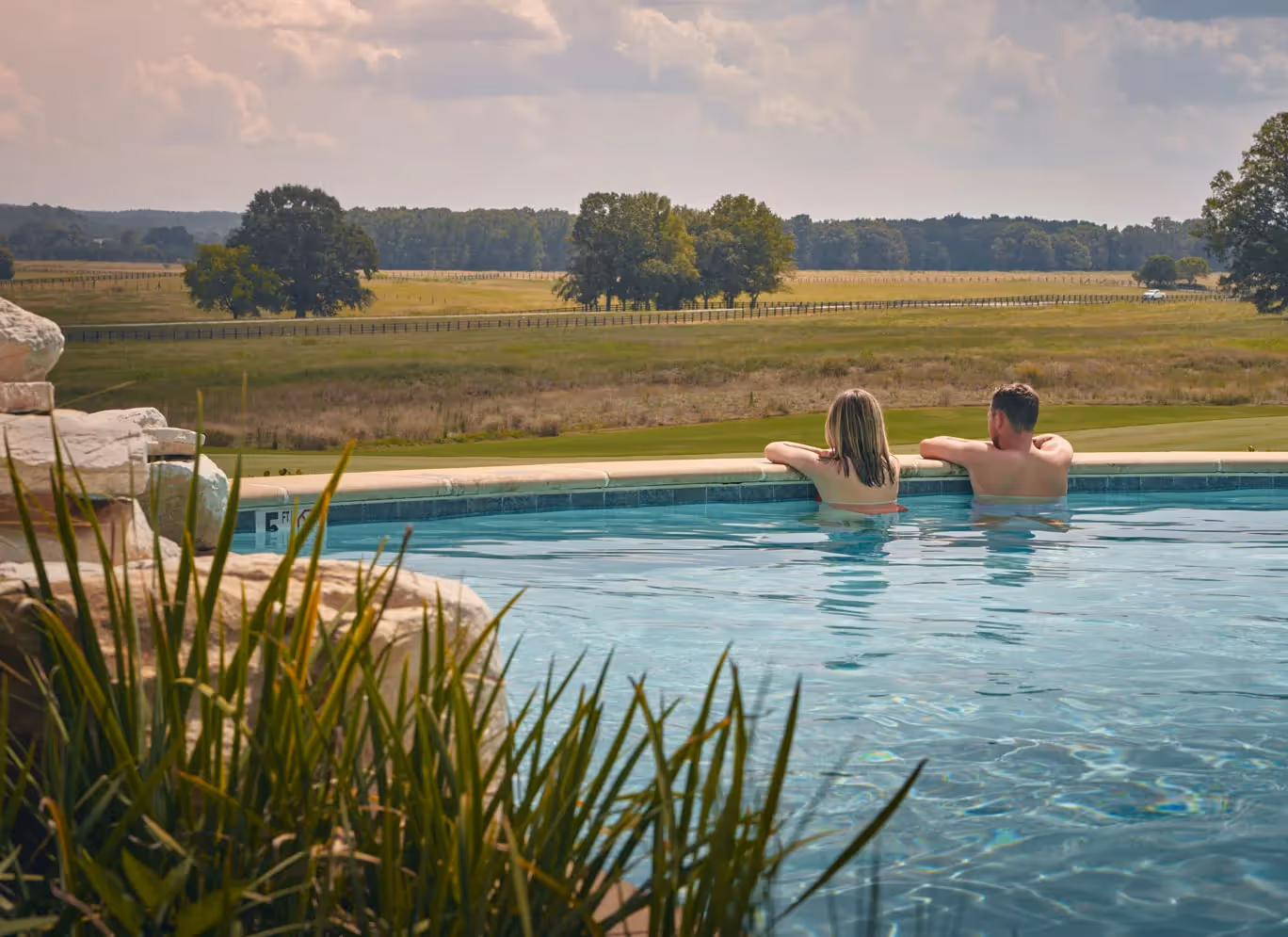 two people relaxing in a pool
