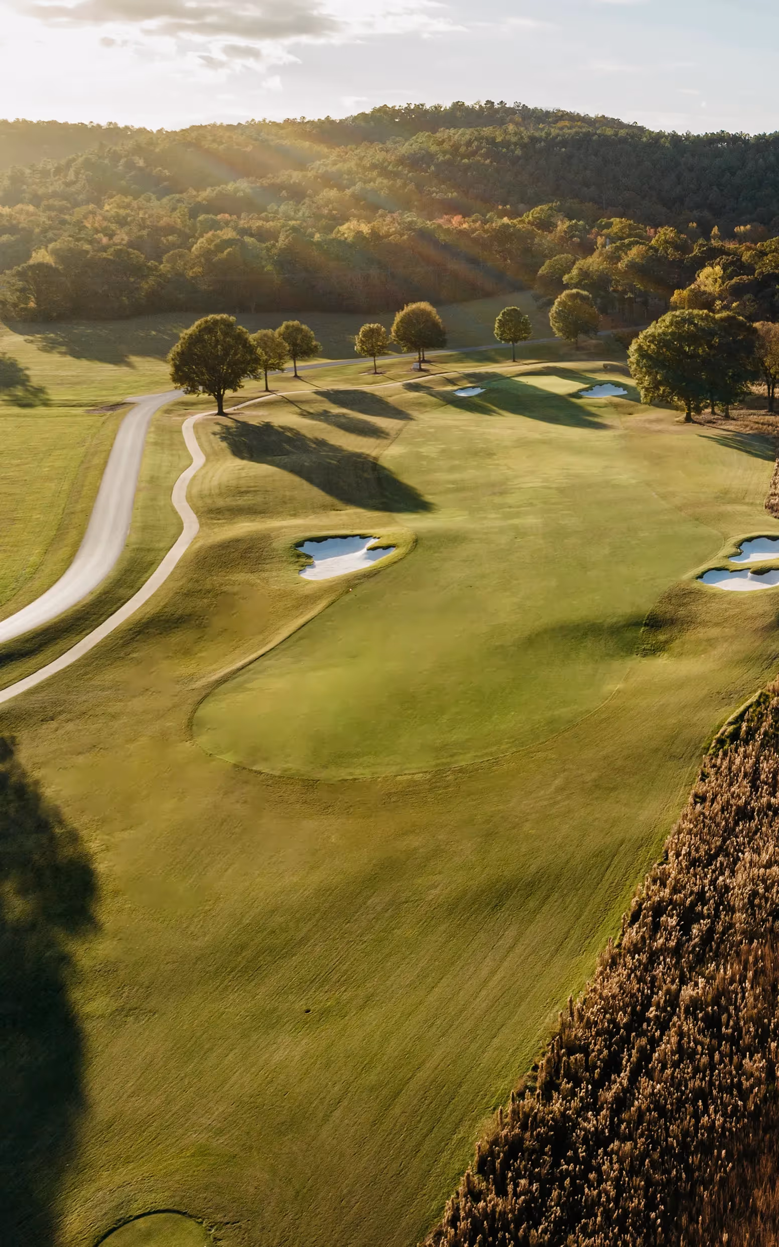 Sky view of open putting green and flag pole with yellow flag
