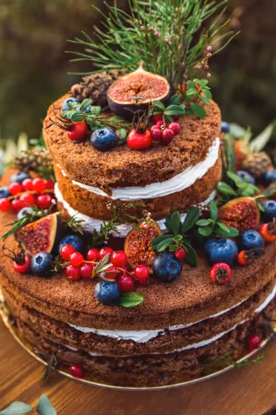 Rustic wedding cake with assorted berries.