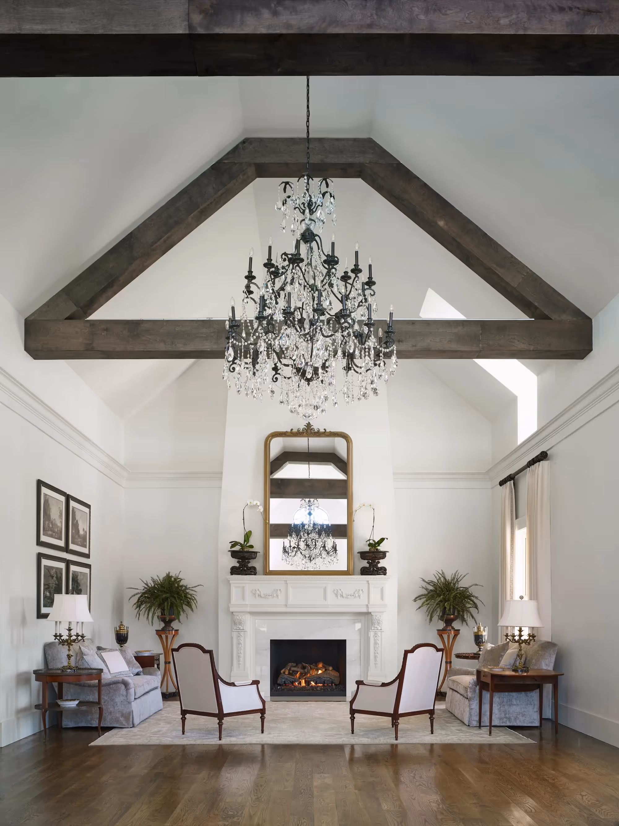 Historic countryside estate, Hamilton Place at Pursell Farms. Featuring exposed wood beams, chandelier, and fireplace.