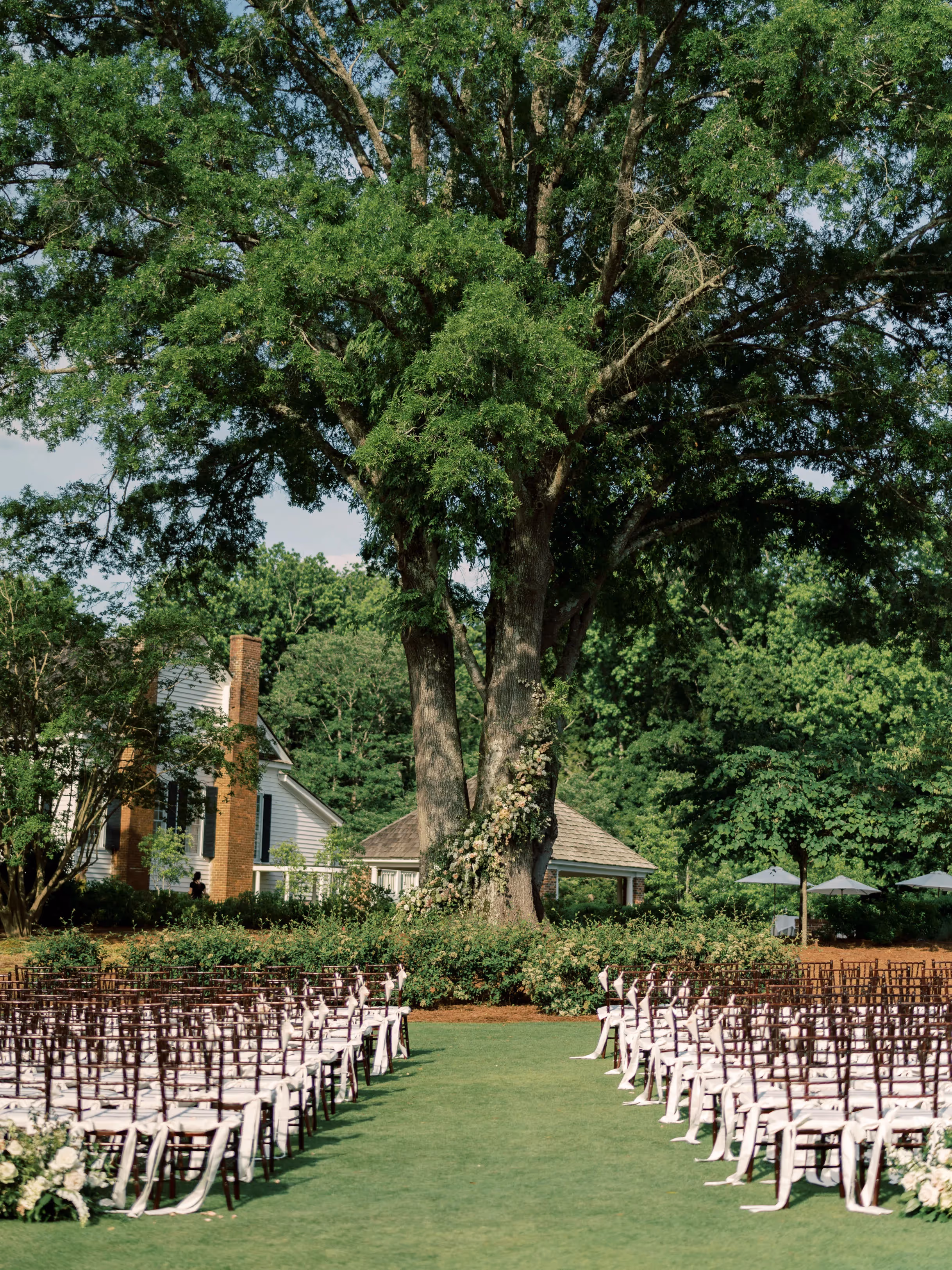 Outdoor rustic themed wedding on the property of Pursell Fams. Ceremony set up under an oak tree.