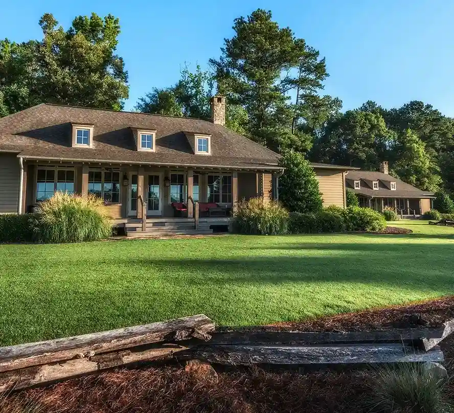 Big houses with logs in the front yard